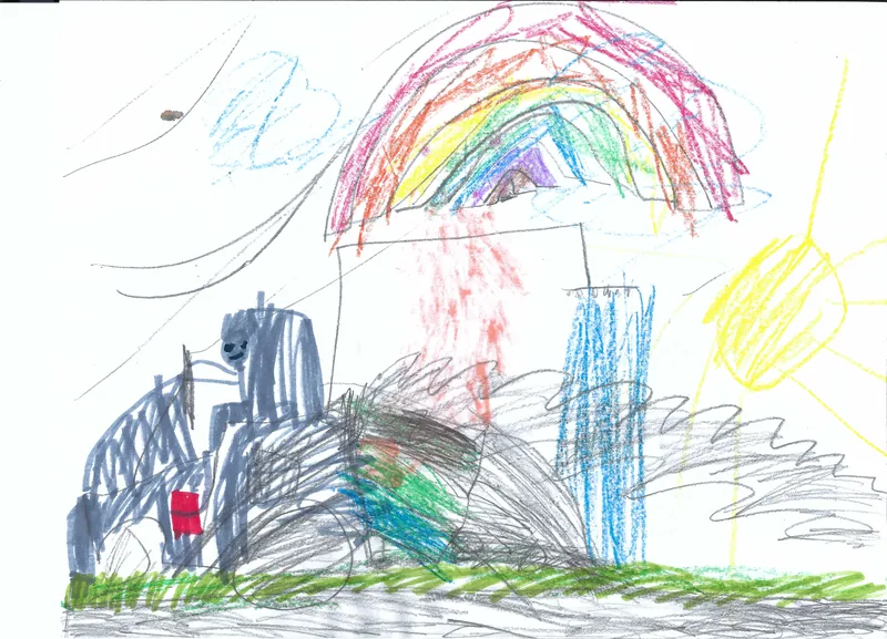 A dark train beneath a rainbow beside a blue building, green ground, clouds, and a yellow sun
